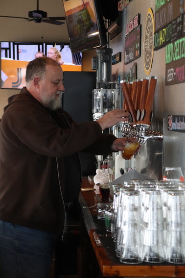 The owner of Barnett and Son Brewing Co. in Parker, Andy Barnett, pours a beer.